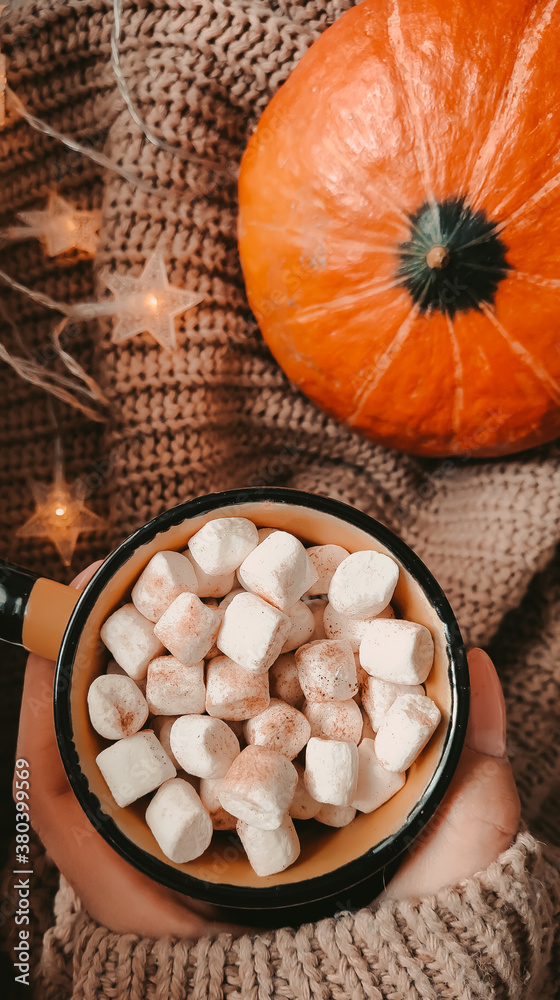 Cup of coffee with marshmallows in hand Cup of coffee with marshmallows in hand