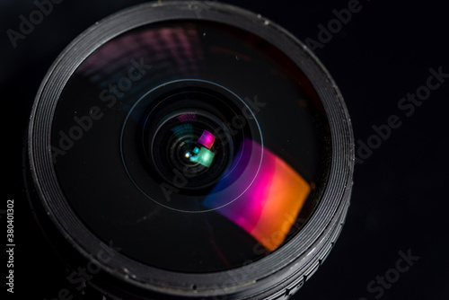 Dusty photo lens on a dark background.