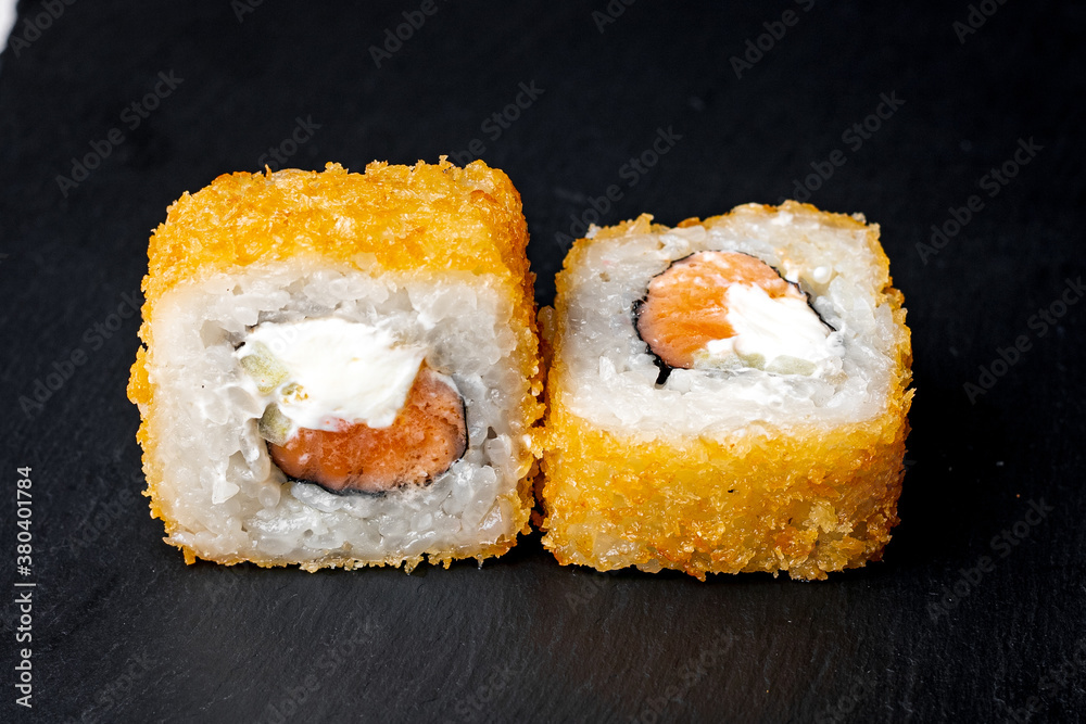 sushi rolls on a black background