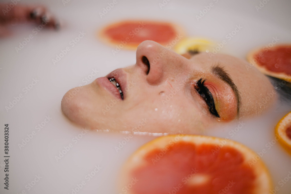 Fototapeta premium woman in milk and juice bath