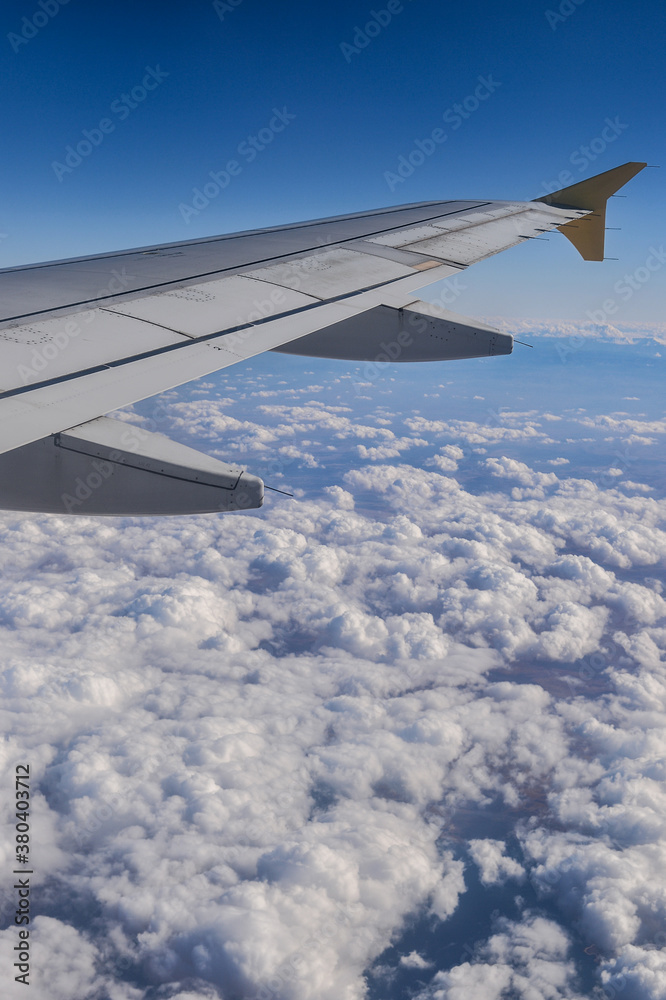 Airplane wing over a sky with clouds Airplane wing over a sky with clouds