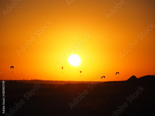 Skydivers at sunset