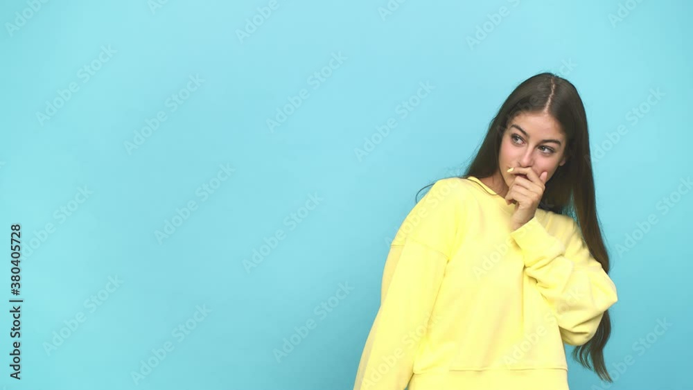 Young caucasian woman thoughtful looking to a copy space covering mouth with hand Young caucasian woman thoughtful looking to a copy space covering mouth with hand