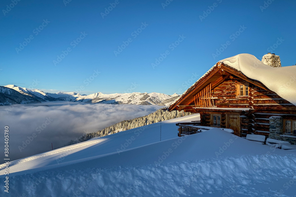 Snow covered mountain hut old farmhouse in the Austrian alps at sunrise against blue sky. Snow covered mountain hut old farmhouse in the Austrian alps at sunrise against blue sky.