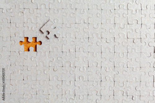 Disassembled puzzle with a last wrong piece impossible to fill