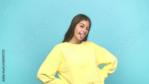 Young caucasian woman funny and friendly sticking out tongue photo