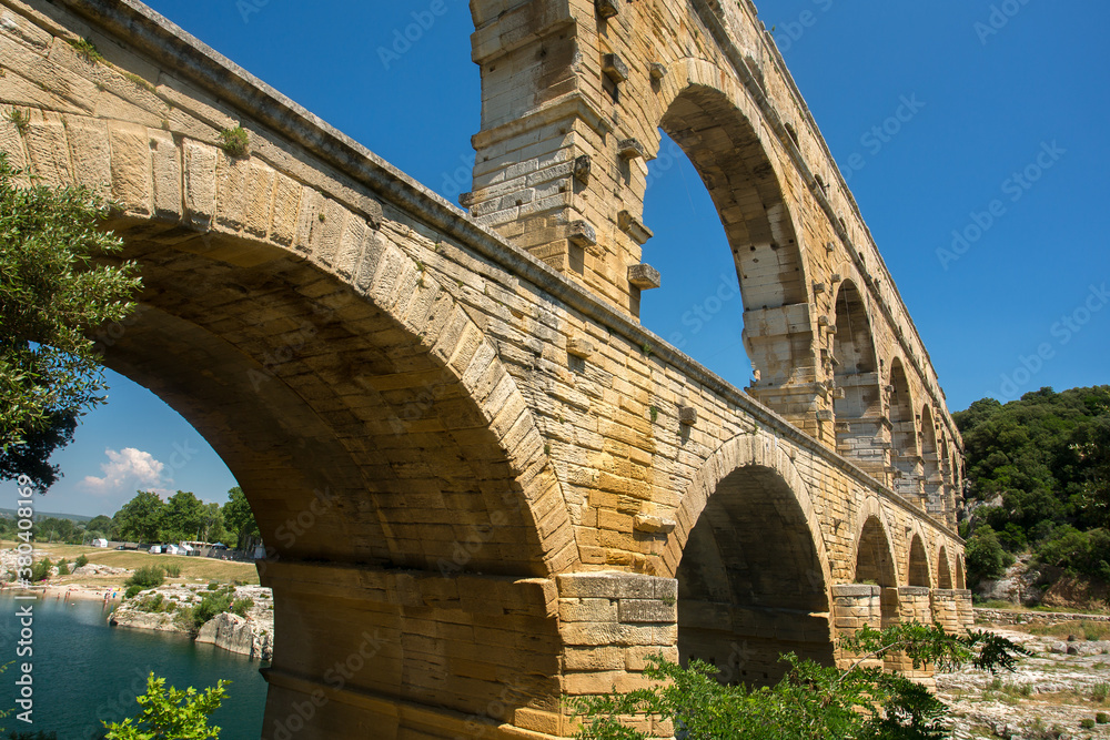 Pont du Gard, a Mighty aqueduct bridge rising over 3 well-preserved arched tiers, built by 1st-century Romans.