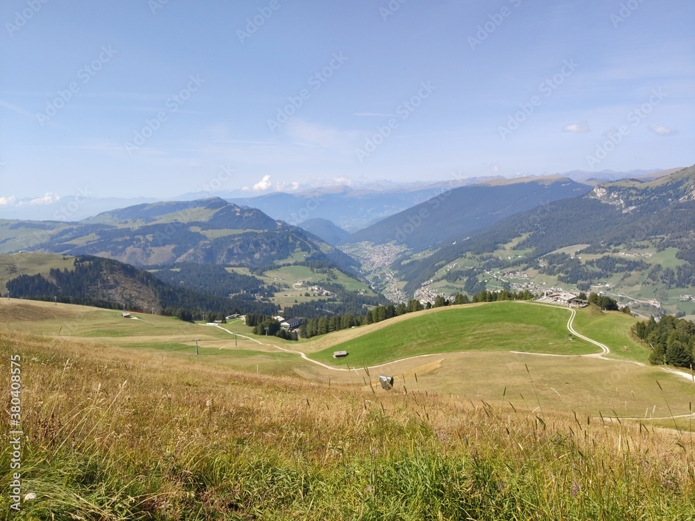 Obraz premium Val Gardena, Italy - 09/15/2020: Scenic alpine place with magical Dolomites mountains in background, amazing clouds and blue sky in Trentino Alto Adige region, Italy, Europe