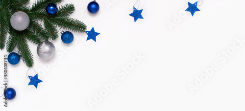 Christmas flatlay with fir branches, blue and silver  decorations on white background. Christmas composition, top view, copy space. New Year background.