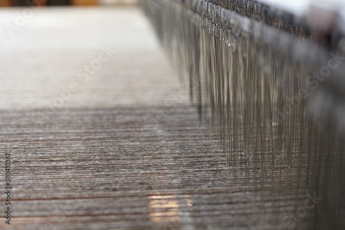 Close up of many meshes and threads of an artisanal loom
