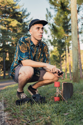Cool skateboarder and photographer.  He has a tool in his hands.  Sport and outdoor concept.