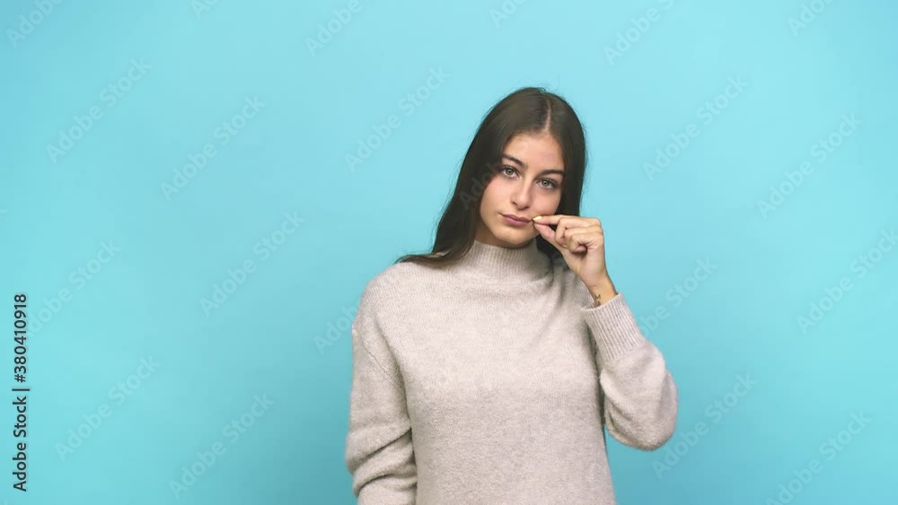 Young caucasian woman with fingers on lips keeping a secret Young caucasian woman with fingers on lips keeping a secret