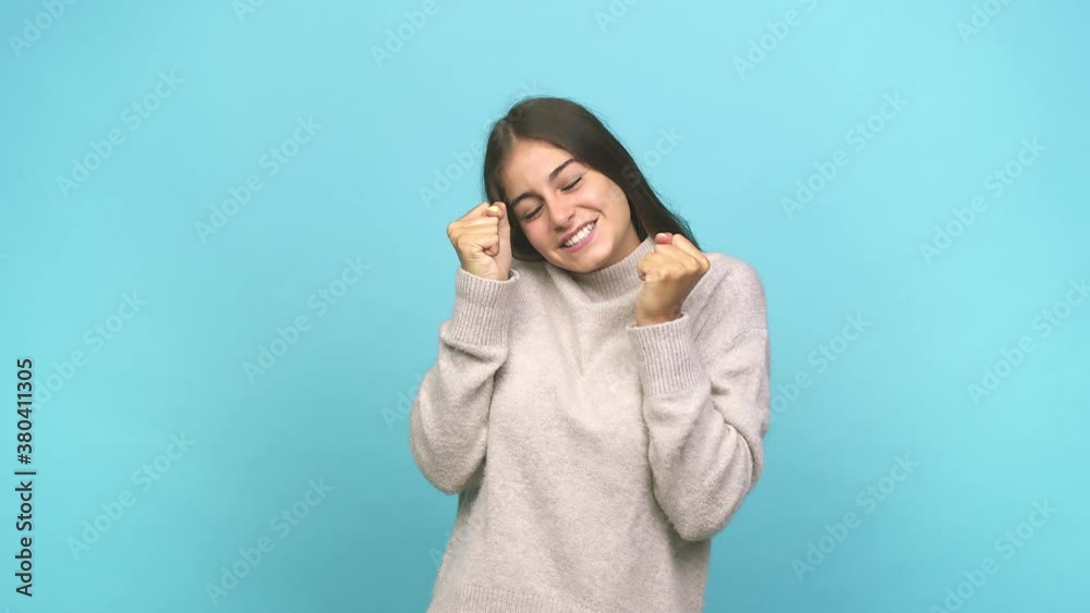 Young caucasian woman raising fist, feeling happy and successful victory concept Young caucasian woman raising fist, feeling happy and successful victory concept