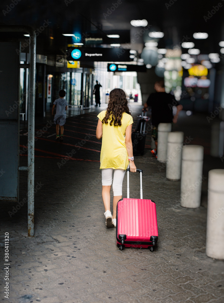 Preteenager girl has arrived at the airport, ready to depart Preteenager girl has arrived at the airport, ready to depart