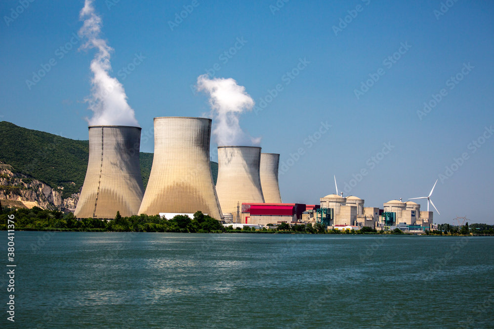 Viviers, France - 6/6/2015: Four Cooling towers, part of a nuclear power plant complex along the Rhone River near Meysse and Cruas, France. Viviers, France - 6/6/2015: Four Cooling towers, part of a nuclear power plant complex along the Rhone River near Meysse and Cruas, France.