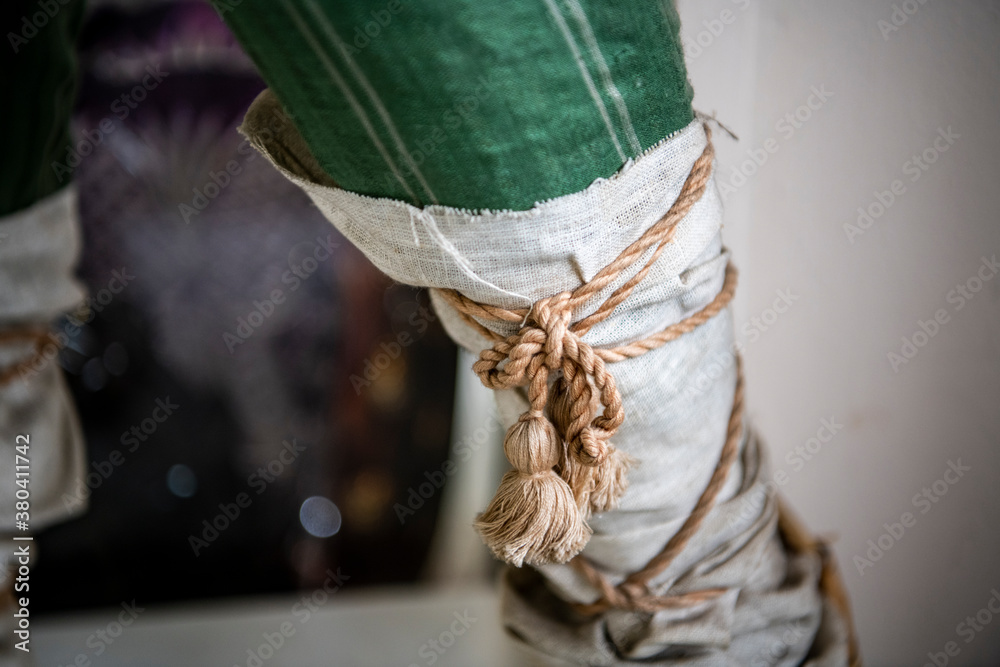 a rope tie on the leg as an element of antique clothing