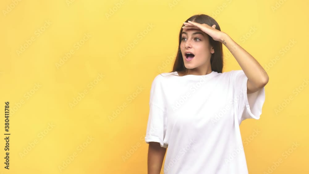Young caucasian woman looking far away keeping hand on forehead Young caucasian woman looking far away keeping hand on forehead