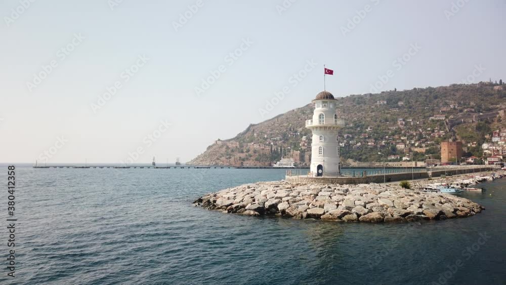 Lighthouse of Alanya. The ship passes next to lighthouse in the port of Alanya. Lighthouse of Alanya. The ship passes next to lighthouse in the port of Alanya.