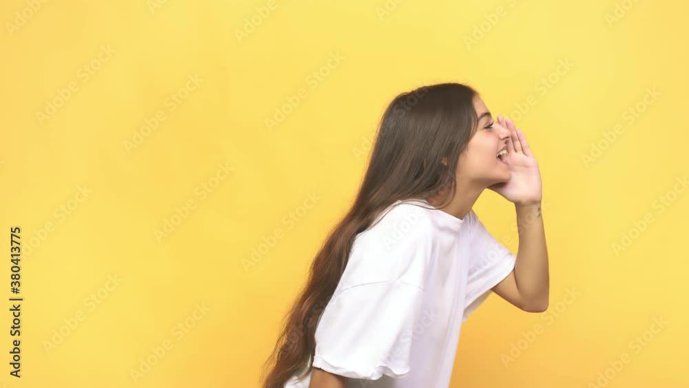 Young caucasian woman shouting and holding palm near opened mouth Young caucasian woman shouting and holding palm near opened mouth