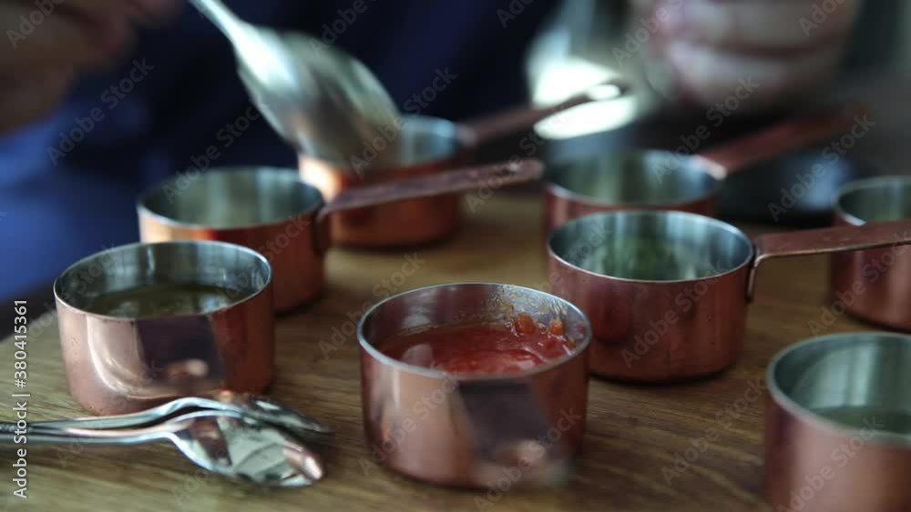 The chef prepares spices in the restaurant at the table. Macro plan The chef prepares spices in the restaurant at the table. Macro plan