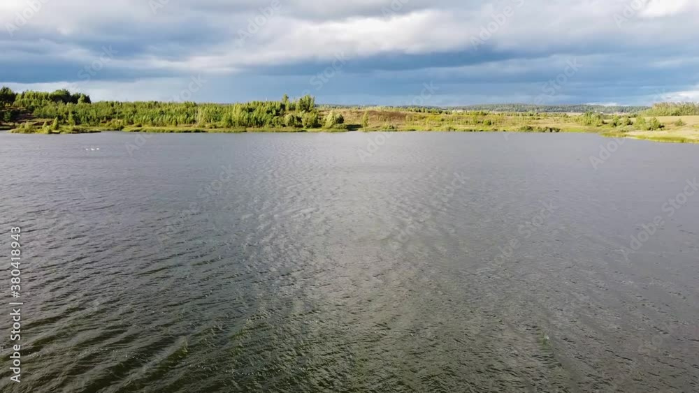 Beautiful smooth flight over the surface of a forest lake in summer Beautiful smooth flight over the surface of a forest lake in summer
