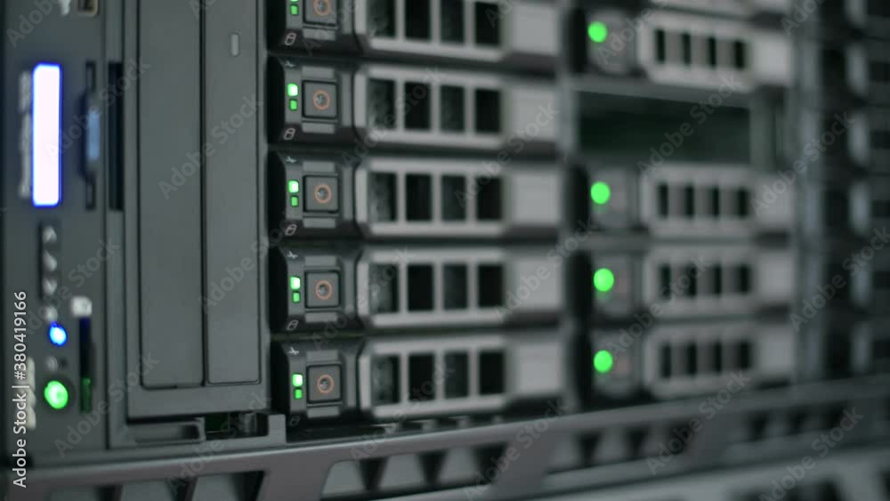 Blinking bulbs on hard drives in a server cabinet, close-up, bokeh. information recording process