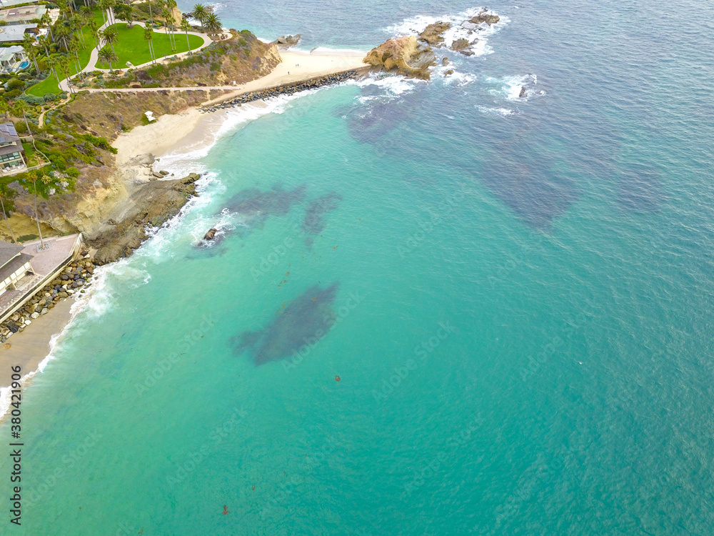 stunning aerial shot of the blue ocean water, the beach front homes