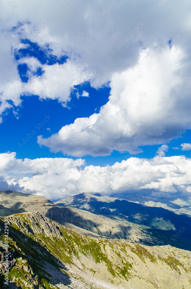 Naklejka premium View from high mountain. clouds in the sky