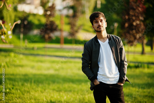 Stylish idian man posed outdoor on sunset. photo