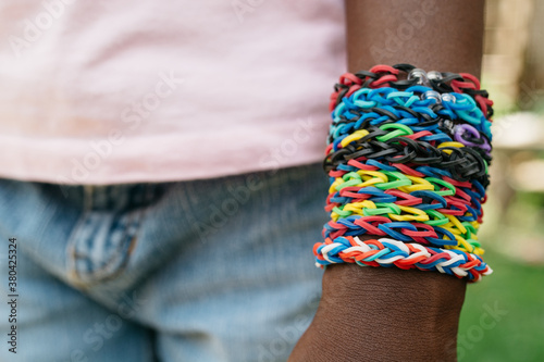 African American girl's arm with rainbow loom bracelets