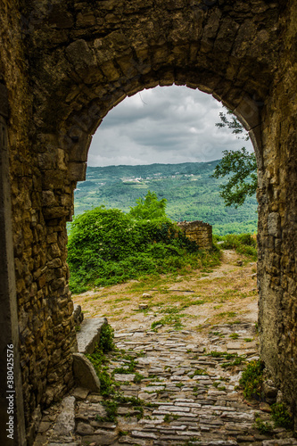 Beautiful old stone entrance and amazing view on the other side photo