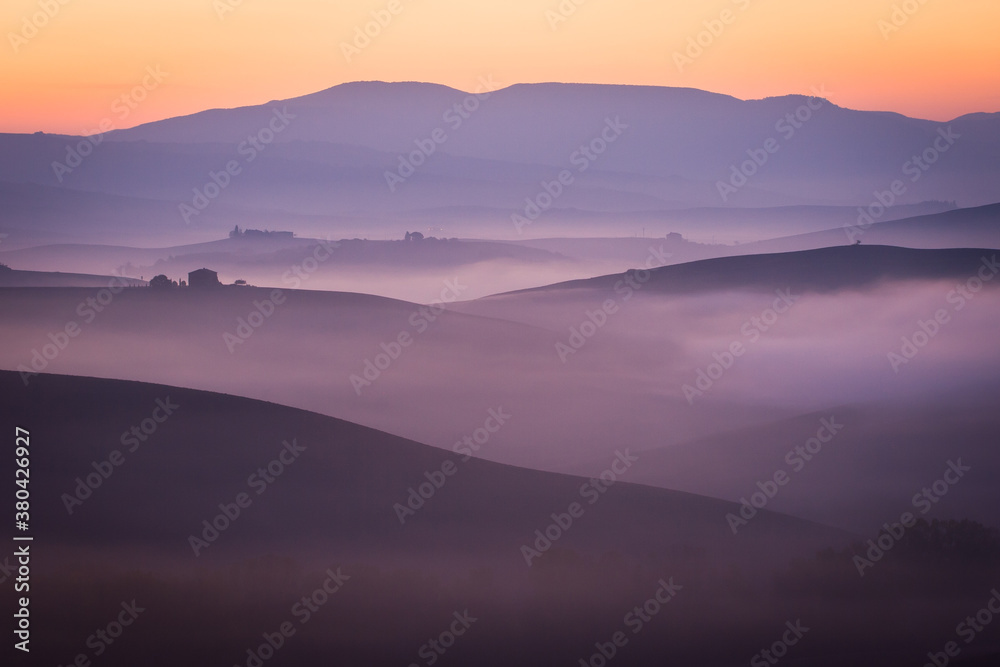foggy hills in autumn colorful morning, italy, tuscany
