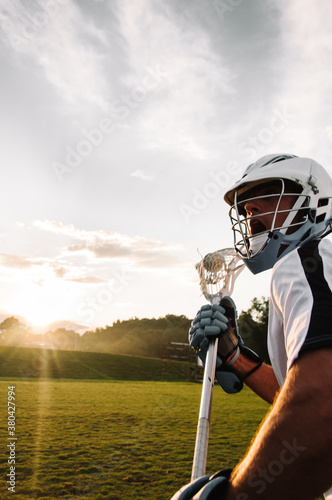 Man playing lacrosse sport and training in field photo