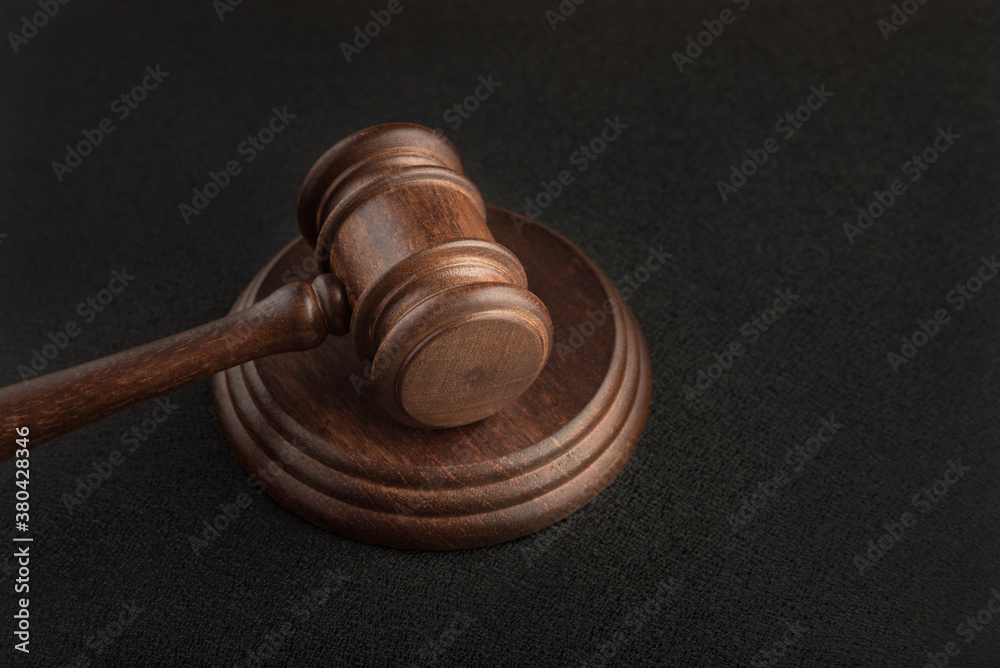 Gavel and sounding block on black background. Justice and law. Close up