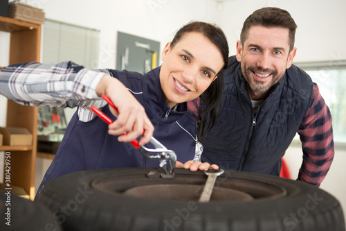 female mechanic repairing a car in a garage photo