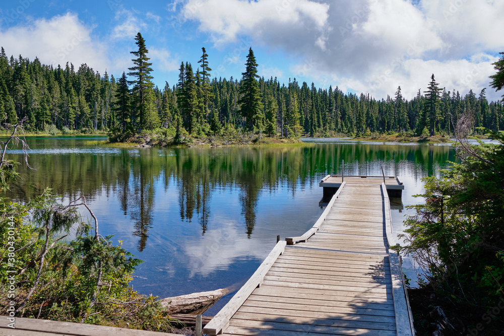 Small jetty juts into tranquil Battleship Lake, Strathcona Provincial Park