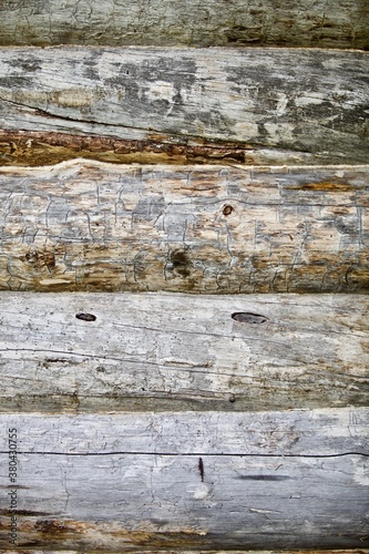 Pine log walls texture close up. Wooden Log cabin walls made from an arctic pine. The frame of a wooden blockhouse. The wall surface fragment of a log village house. Old pine log wall full frame.