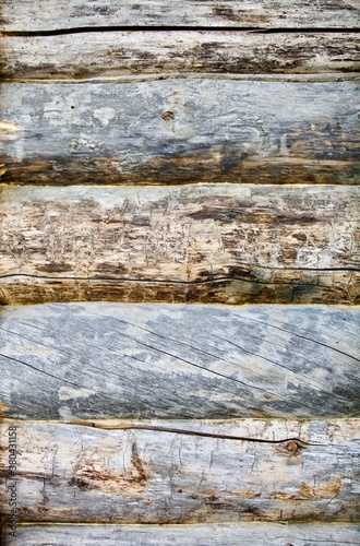 Pine log walls texture close up. Wooden Log cabin walls made from an arctic pine. The frame of a wooden blockhouse. The wall surface fragment  of a log village house. Old pine log wall full frame.