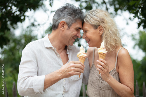 happy old couple eating ice-cream outdoor