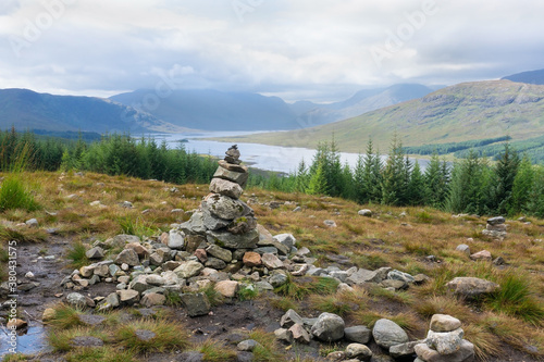 Rock stack in front of Loch Loyne in Scotland © 13threephotography