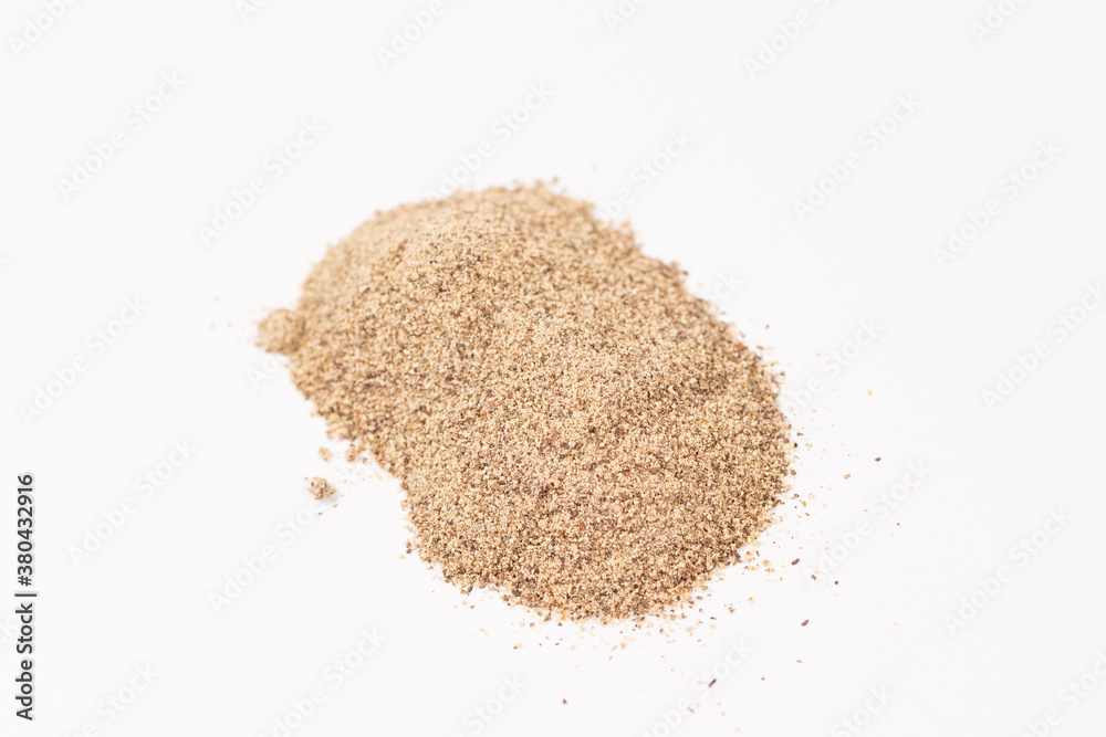 Powdered black ground pepper pile from top on white background Powdered black ground pepper pile from top on white background