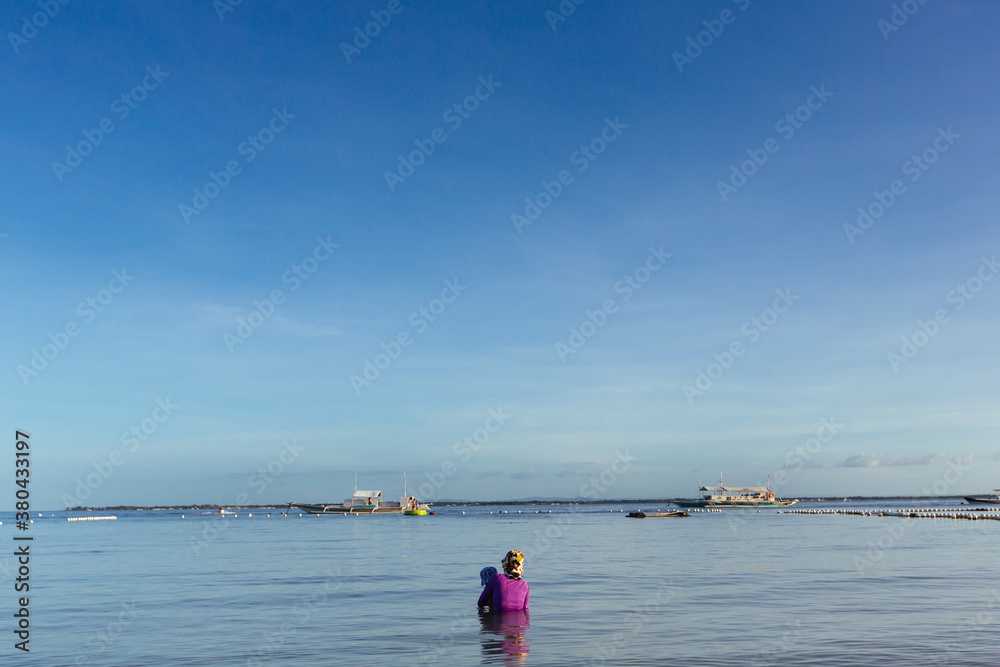 Mother and son taking a dip in the sea Mother and son taking a dip in the sea
