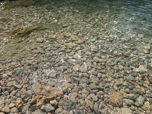 Sea stones on the beach. Crystal clear water. Pebble beach. Tranquility. Calm.