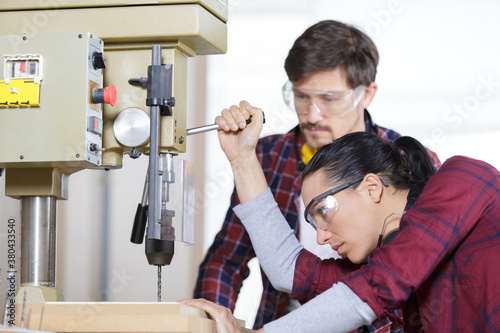 Photos carpenter with student in woodworking workshop