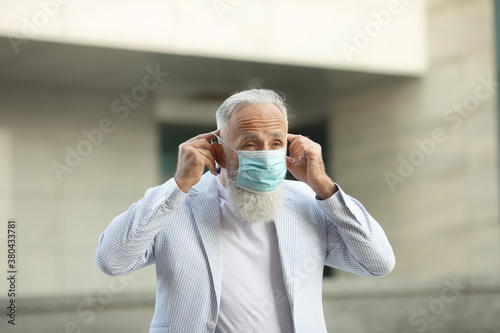 Portrait of senior man wearing medical mask. Coronavirus concept. Respiratory protection. Covid-19.