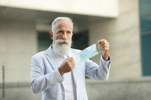 Portrait of senior man wearing medical mask. Coronavirus concept. Respiratory protection. Covid-19.