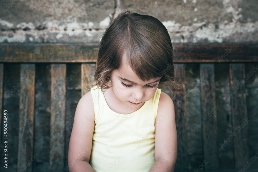 Little girl sitting on a bench Little girl sitting on a bench