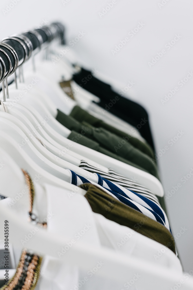 clothes on white hangers in a shop clothes on white hangers in a shop