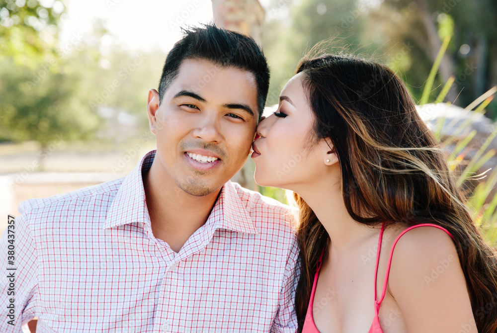 Girlfriend kissing boyfriend on the cheek Girlfriend kissing boyfriend on the cheek