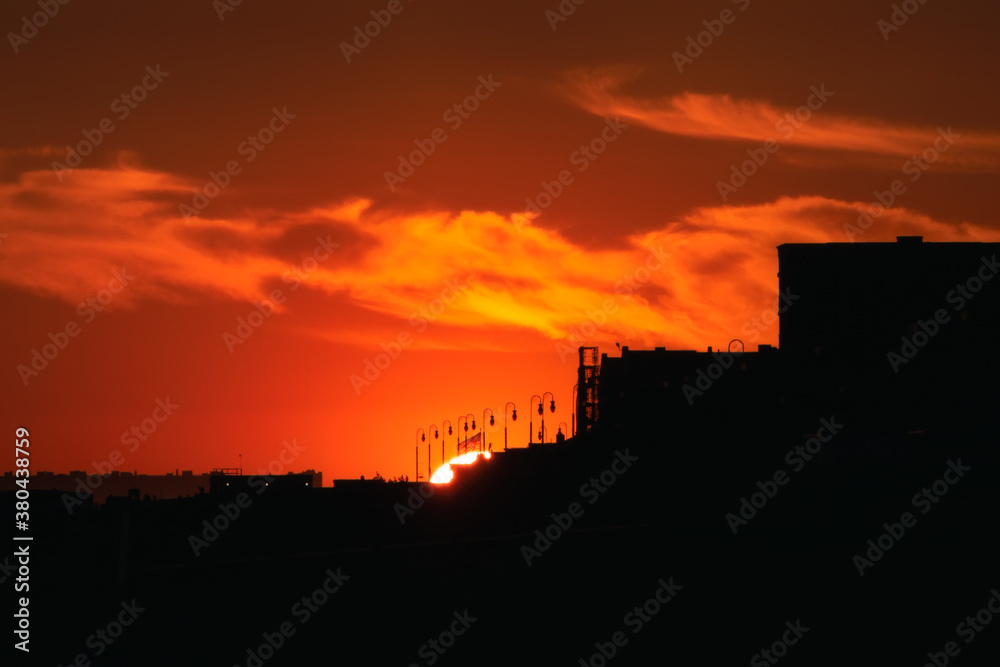 Silhouette of a beach town and boardwalk against a vibrant sunset. Long Beach New York. Silhouette of a beach town and boardwalk against a vibrant sunset. Long Beach New York.